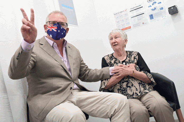 Australia administers first Covid-19 vaccines