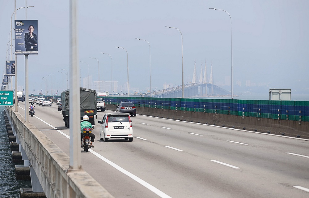 Boy, 10, stops traffic on Penang Bridge for help as father jumps into sea to save mother who fell over
