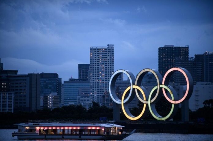 Japan PM warns of closed-door Olympics as virus cases rise