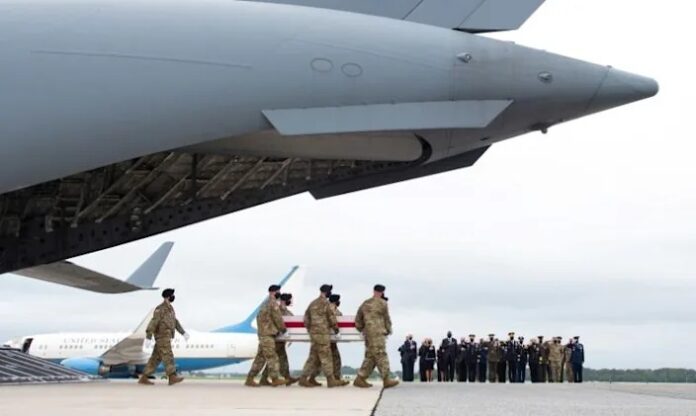 Biden in solemn ritual over remains of fallen US troops