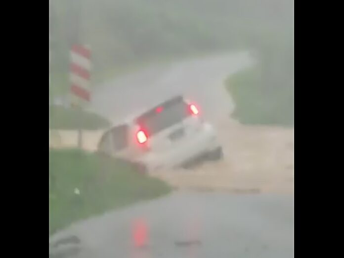 Car swept away by flood water when crossing bridge in Sabah