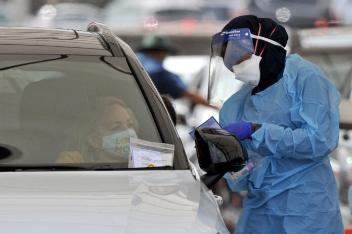 Australia's Omicron outbreak strains testing clinics as cases hit records
