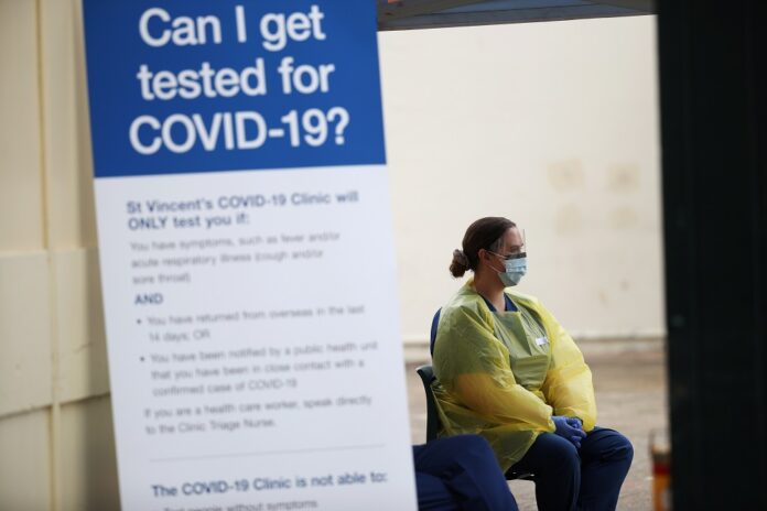 Australia treasurer tests positive for Covid-19 as cases hit a record