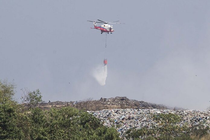 Fire Dept drops water bombs to put out blaze at Pulau Burung landfill