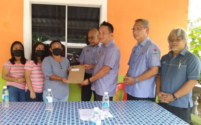 Twins in Sarawak receive Socso benefits 13 years after mother's death