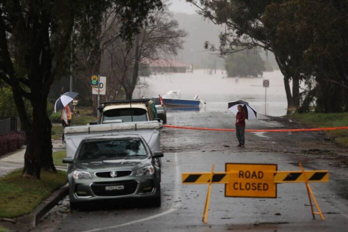 Thousands of Sydney residents return home to assess damage as flood waters recede