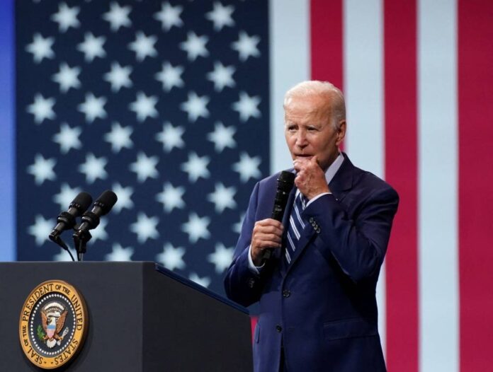 Biden confronts extremism at perilous moment for presidency, country