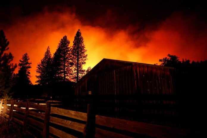 Thousands told to evacuate as rapid wildfire spreads in California