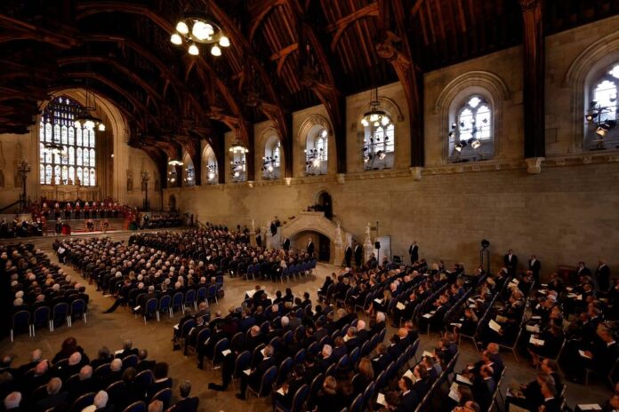 King Charles, in Parliament, promises to follow queen's example