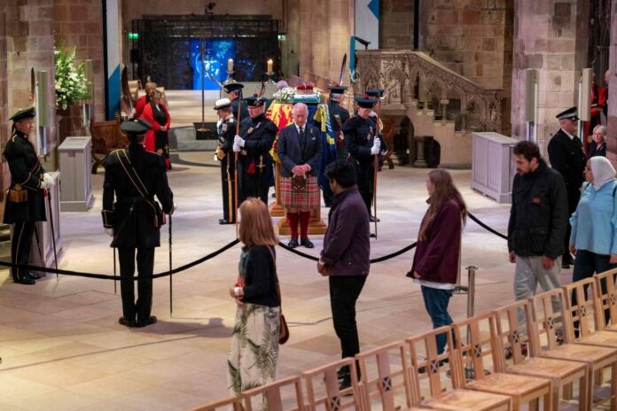 Crowds queue through the night in Scotland for queen