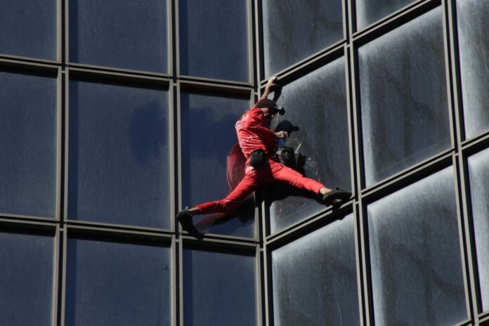'French Spiderman' climbs Paris skyscraper to mark turning 60