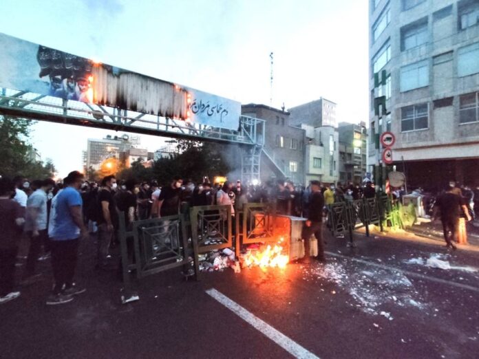 Iranian protesters set fire to police station as unrest over woman's death spreads