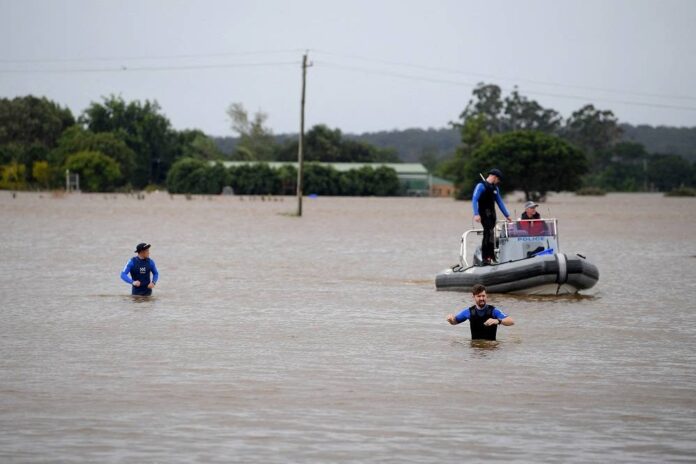 Boy dies as car swept away in floods near Sydney