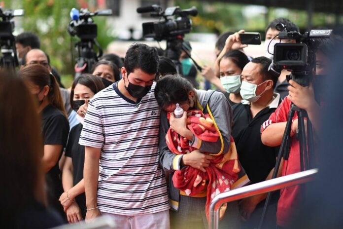 Day after Thai attack, traumatised relatives cling to slain children's toys