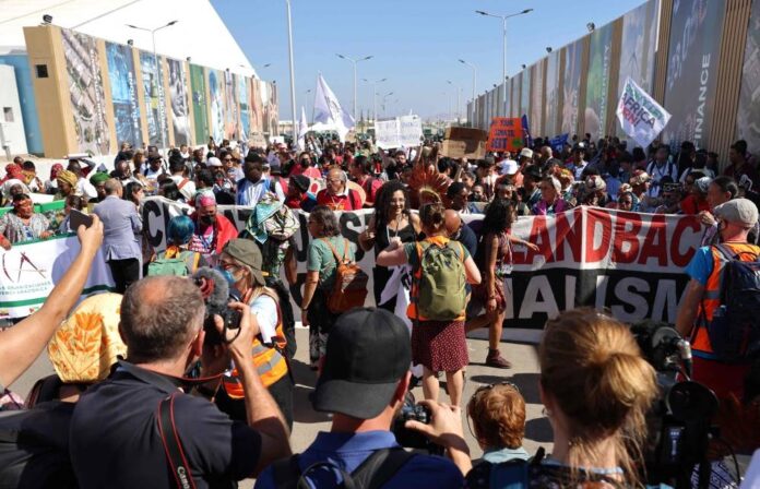 At COP27, hundreds march behind hunger striker's sister